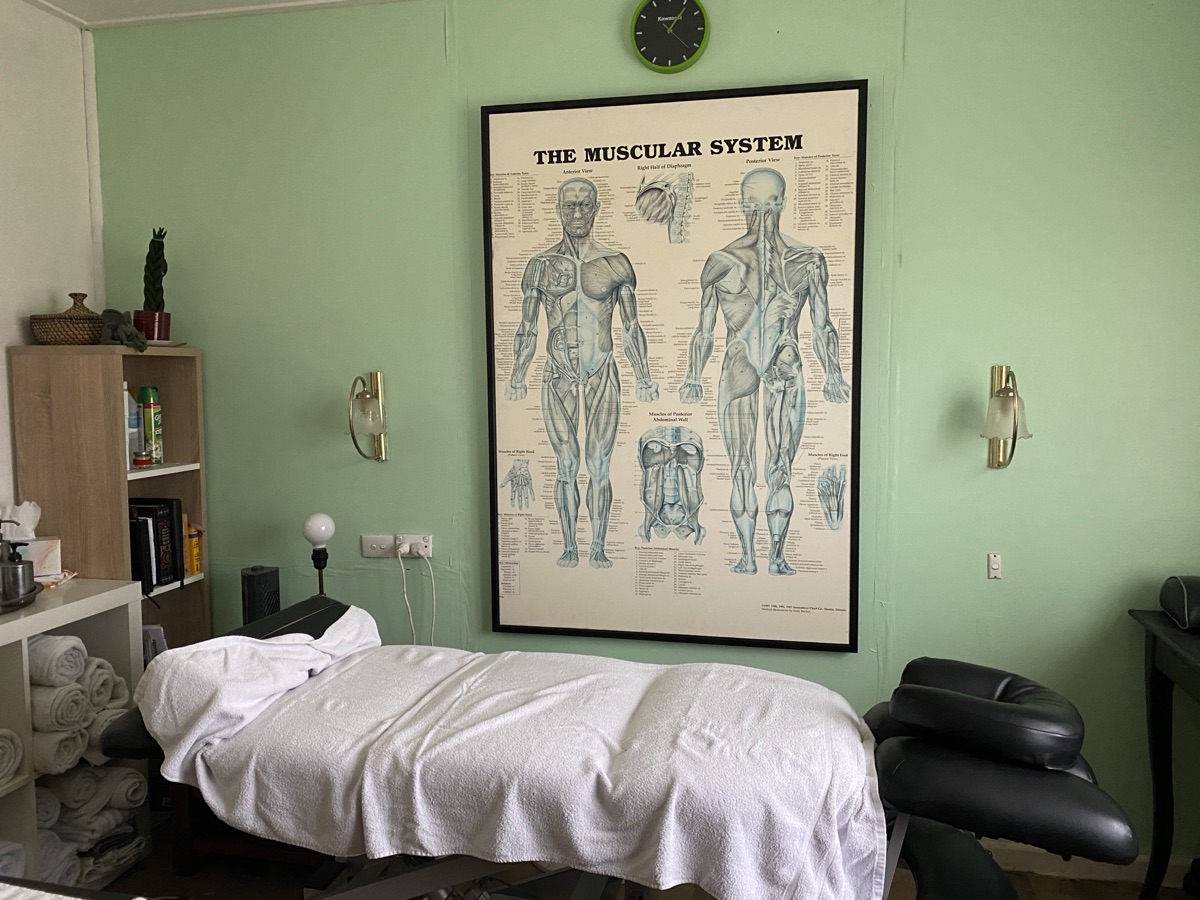 The treatment room at The Marshall Method, with anatomy chart and treatment bed